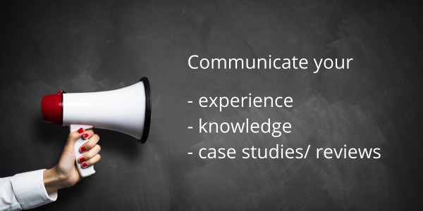 blackboard, loud speaker and words: communicate your experience