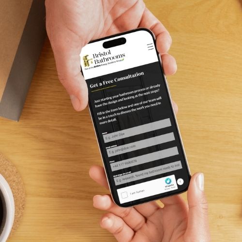 a mobile phone with bristol bathrooms website on being passed between two hands